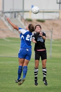 Raider Ashley Cheney uses her head against a Santa Monica Corsair attacker at Raider Field on September 11, 2009. The Raiders and the Corsairs tied, 2-2. 