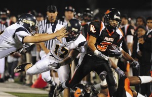 Breaking away– Ventura College’s Khristian Guillory, right, trys to avoid the following College of the Canyons Cougars defense during a National Northern Conference  game Saturday night at Ventura College. The Pirates forced five turnovers on defense, and won the 126 Highway rivalry 23-6.