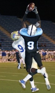 Moorpark's Chris Grant goes up for a touchdown catch in a game against Allan Hancock College Saturday night. The Raiders lost the game 63-28, and remain winless.