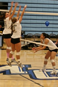 MV vball 11/17 Raiders setter Olivia White and middleblocker Rachel Olinyk, both left, go up for a block during warm-ups before Tuesday night's WSC match.