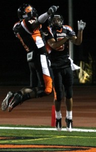 Patrick Hebert, left, and Nick Karam, right, celebrate Karam's touchdown catch during a game against Allan Hancock College Saturday night. Karam had two touchdown catches on the night in a 28-21 loss to the Bulldogs.