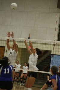 Middleblockers Chelcy Westphal, left, and Una Siljegovic, right, attempt to block a kill attempt by Allan Hancock during a WSC match Friday night. The Raiders swept the Bulldogs in three sets.