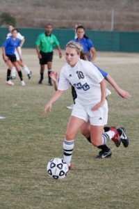 The Raiders' No. 10 advances the ball down the field in a regional final playoff game at Santiago Canyon Saturday afternoon. The Raiders eventually lost the game 1-0.