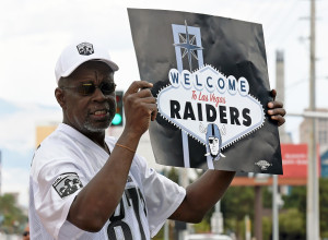 Oakland Raiders fan Davi Tole of Nevada displays a sign to passing motorists after NFL voters approved Raiders' move to Las Vegas. (Photo by Ethan Miller/Getty Images)